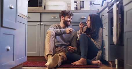 Smile, couple and eating ice cream in kitchen for love, sharing dessert and bonding together. Happy, people and relax with sweet treats of romantic date, frozen snack and marriage commitment at house