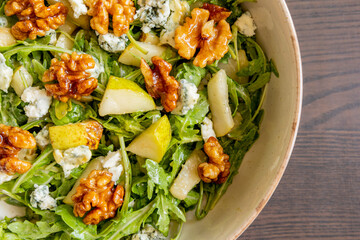 healthy fall salad with arugula pear cheese and candied walnuts