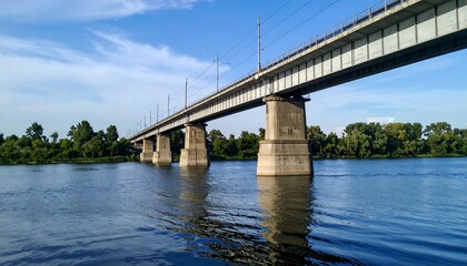 Naklejka premium Concrete railway bridge cutting across river, calm and clean framing
