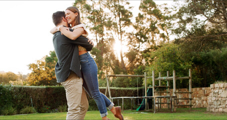 Happy, couple and hug or lift in garden for trust, energy and love with care outdoor for romance. Marriage, support and excited for healthy relationship with man carrying woman for bonding in nature