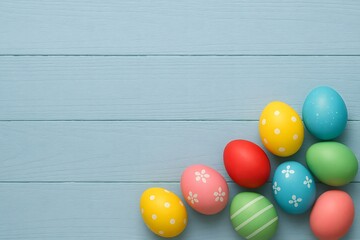 Obraz premium Colorful Easter Eggs on Blue Wooden Background with Copy Space