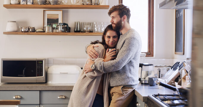 Coffee, hug and morning with couple in kitchen of home together for bonding, safety or security. Drink, love and smile with portrait of woman on chest of man, embracing in apartment for trust