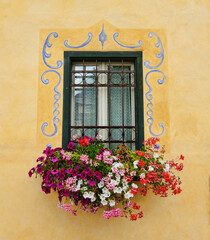 Colorful windows with flowers, Cortina d'Ampezzo, Italy