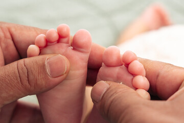 Close-up of Hands Gently Holding Babys Feet