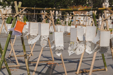 Traditional handmade paper lanterns made from saa paper hanging on bamboo frame displayed outdoor,...