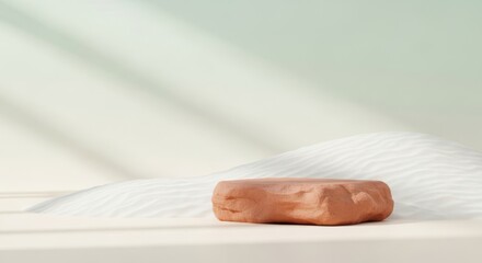 Obraz premium Minimalist desert scene with natural stone podium and soft lighting