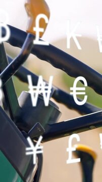 Currency symbols animation over close-up of tractor steering wheel in field