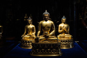 Row of golden Buddha statues in temple