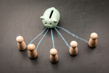 Piggy bank distributing money to multiple people as financial concept