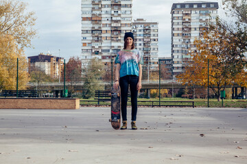 Portrait of young woman with skateboard
