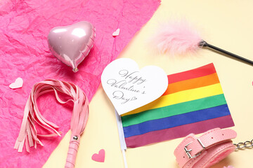 Festive postcard with rainbow LGBT flag, sex toys and decor on yellow background. Valentine's Day...