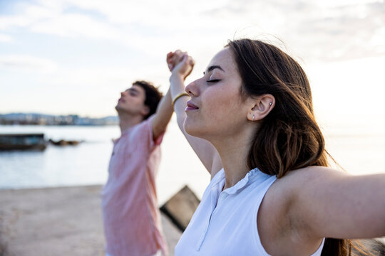 Girlfriend with eyes closed standing by boyfriend