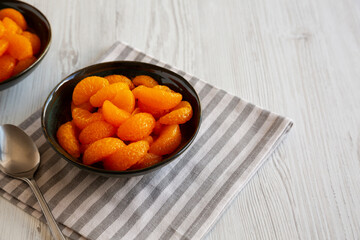 Organic Canned Mandarin Oranges in Bowls, side view. Copy space.
