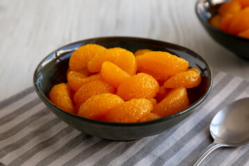 Organic Canned Mandarin Oranges in Bowls, side view. Close-up.