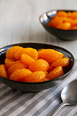 Organic Canned Mandarin Oranges in Bowls, side view. Close-up.