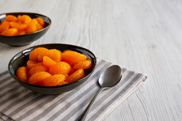 Organic Canned Mandarin Oranges in Bowls, side view. Copy space.