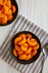 Organic Canned Mandarin Oranges in Bowls, top view. Copy space.