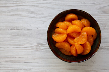 Organic Canned Mandarin Oranges in Bowls, top view. Copy space.