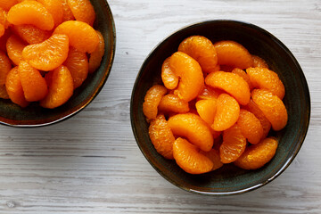 Organic Canned Mandarin Oranges in Bowls, top view. Close-up.