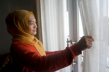 Young Asian Woman Looking Out From The Window