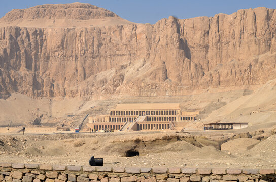 View of the majestic Temple of Khonsu standing against the backdrop of rugged cliffs in the golden landscape, Philae Temple, Luxor Governorate, Egypt.