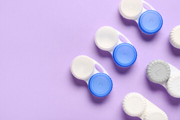 Containers for contact lenses on lilac background
