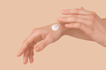 Fototapeta premium Female hands with natural cream on color background, closeup