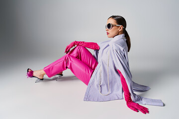 Chic young woman showcases innovative fashion with bold pink accents and striking style