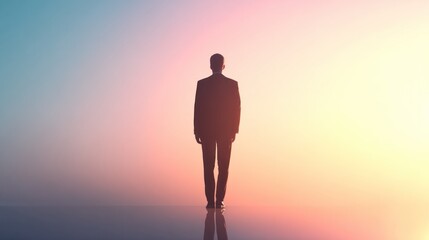 Silhouette of a businessman standing against a colorful gradient sky