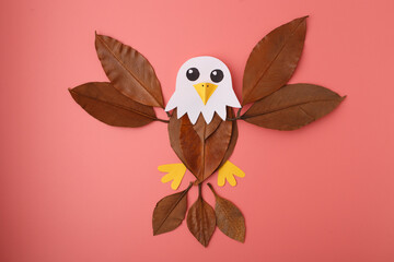 Handmade eagle collage using leaves and paper on pink background, ideal for eco education, children books, DIY craft blogs, nature branding, and creative school projects.