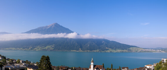 Morning cloud band over the Zug lake with Swiss Alps Rigi Peak at the background