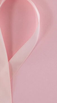 Animation of pink ribbon and tulip on pink background