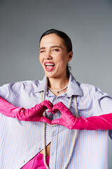 Stylish young woman expresses joy and creativity in a trendy pink-accented outfit