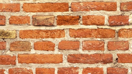 Close-up of an old brick wall, showing texture and detail.