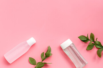 Organic cosmetics for face clearing with facial tonic and mycelial water on pink background top view copy space