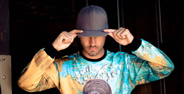 Stylish young man wearing basecap and printed shirt