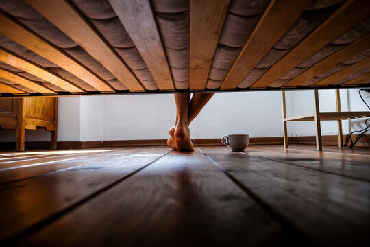 Woman waking up, slatted frame and coffee cup