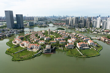 Aerial view of an exclusive island community with luxury villas, contrasting with a modern city...