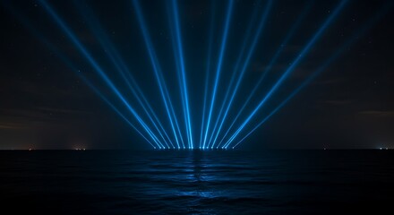 Dramatic Blue Light Beams Illuminate the Night Sky Over a Dark Ocean Horizon, Creating a Spectacular Visual Display.