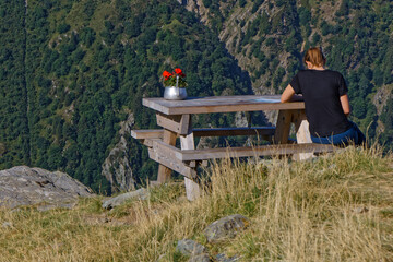 UNrecognizable woman at rest on the slopes near Refuge Jean Collet, a halt for hikers on the path...