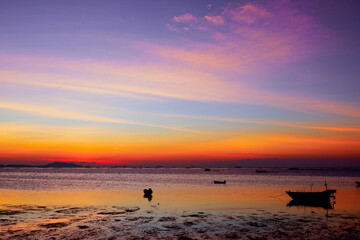 sunset in the sea. Beautiful colorful sky and cloud in twilight time background. Orange fluffy clouds and sun sunlight reflection in the blue sky.