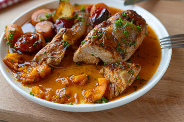 Braised chicken breast with vegetables and sauce on a plate. Delicious healthy and low fat dinner. Protein rich