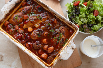 Oven braised chicken breast with delicious sauce and vegetables in a casserole dish