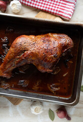 Oven roasted whole turkey leg or shank with gravy in a baking pan fresh and homemade cooked