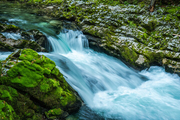 Vintgar gorge waterfall over mossy rocks
