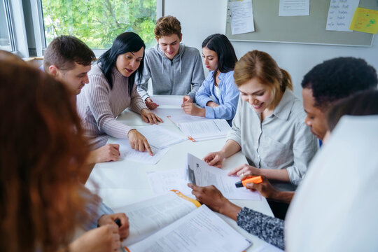 Multi-ethnic students studying together at desk in training class