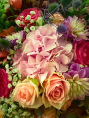 Colorful floral arrangement featuring roses, hydrangeas, and mixed blossoms, radiating joy and festive elegance