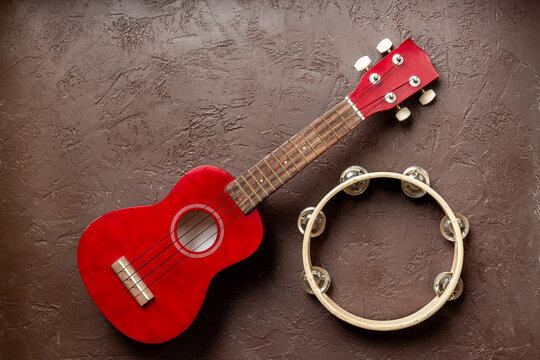 Musical instruments - small guitar and tambourine top view
