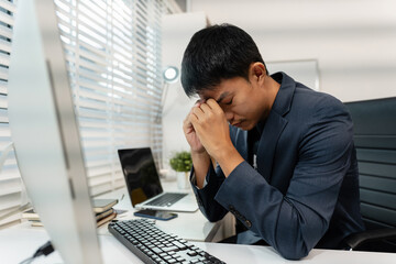 stressed asian businessman working in the office. Businessman thinking too much work concept in the...