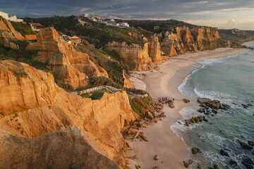 Portugal’s Praia de Vale Furado – wild Atlantic beach with golden cliffs, soft sand and...